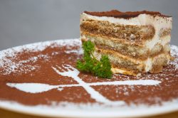Tiramisu: İtalya'dan Dünyaya Uzanan Tatlı Hikayesi tiramisu dessert served on plate with cpecial decoration. shallow dof.